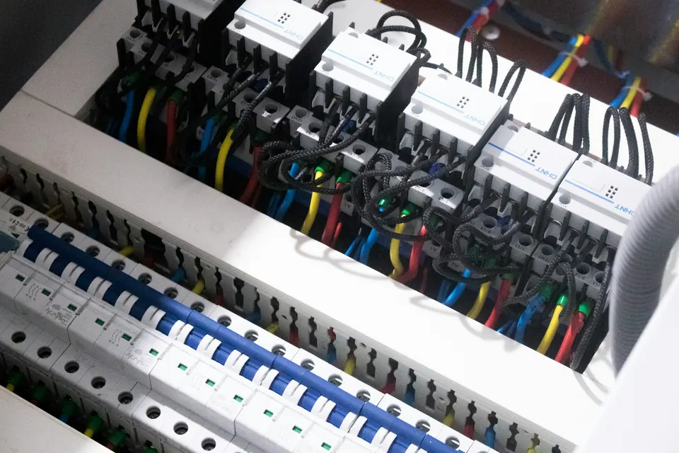 Geopende kast met automaten en gekleurde draden
